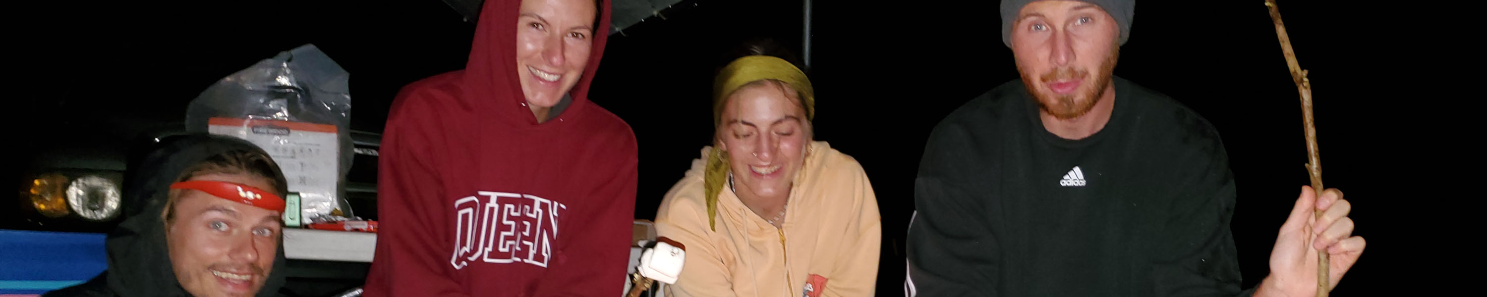 Team members gathering around a campfire during a power outage